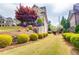 Landscaped front yard featuring shrubs, mulch beds, and stone and siding exterior at 3318 Monceau Way, Roswell, GA 30075