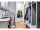 Hallway with built-in storage, hardwood floors, and staircase at 3318 Monceau Way, Roswell, GA 30075