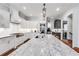 Bright kitchen featuring granite countertops, stainless steel appliances, white cabinetry, and a large island at 3318 Monceau Way, Roswell, GA 30075
