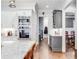 Bright kitchen featuring granite countertops, stainless steel appliances, white cabinetry, and a large island at 3318 Monceau Way, Roswell, GA 30075