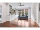 Bright living room with hardwood floors, built-in shelving, and a comfortable blue sofa at 3318 Monceau Way, Roswell, GA 30075