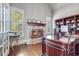 Cozy office with a stone fireplace, built-in shelves, and a large wooden desk at 3318 Monceau Way, Roswell, GA 30075