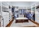 Spacious walk-in closet with custom shelving and a central seating area at 3318 Monceau Way, Roswell, GA 30075
