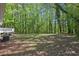 Large, treed backyard with a deck in the distance, great for outdoor activities and relaxation at 3690 Asbury Sw Ln, Atlanta, GA 30331