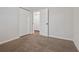 Neutral bedroom featuring carpet floors, closet, and open door to additional storage space at 3690 Asbury Sw Ln, Atlanta, GA 30331