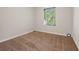Empty carpeted room offers a sunlit window and neutral color palette at 3690 Asbury Sw Ln, Atlanta, GA 30331