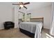 Neutral guest bedroom with plush carpet, double closet, and a view to the front yard at 3690 Asbury Sw Ln, Atlanta, GA 30331