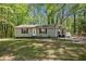 Inviting single-Gathering home with a manicured lawn and mature trees, offering a serene and private setting at 3690 Asbury Sw Ln, Atlanta, GA 30331