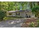 Charming single-story home featuring a well-maintained lawn and a cozy front porch nestled in a lush, wooded setting at 3690 Asbury Sw Ln, Atlanta, GA 30331