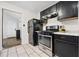 Well-equipped kitchen featuring black appliances, ample counter space, and modern tile flooring at 3690 Asbury Sw Ln, Atlanta, GA 30331