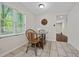 Cozy eat-in kitchen with wood floors, a quaint table set, and natural light filtering through the window at 3690 Asbury Sw Ln, Atlanta, GA 30331