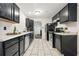 Stylish kitchen with stainless steel appliances, black cabinets, light countertops, and modern flooring at 3690 Asbury Sw Ln, Atlanta, GA 30331