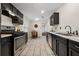 Spacious kitchen with stainless steel appliances, dark cabinets, and a dining area for casual meals at 3690 Asbury Sw Ln, Atlanta, GA 30331