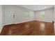 Bright living room with gleaming hardwood floors, fresh paint, and natural light streaming through the windows at 3690 Asbury Sw Ln, Atlanta, GA 30331