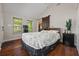 The main bedroom features wood flooring, a barn door, and sun-drenched windows at 3690 Asbury Sw Ln, Atlanta, GA 30331