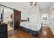 Bright main bedroom boasts hardwood floors, closet, ensuite bathroom, and a decorative barn door at 3690 Asbury Sw Ln, Atlanta, GA 30331