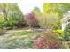 This home features a sprawling backyard with mature trees, colorful plantings, and a well-manicured lawn, creating a private oasis at 4579 Blakedale Ne Cir, Roswell, GA 30075