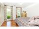 Bright bedroom features hardwood floors, neutral paint, and windows overlooking the yard at 4579 Blakedale Ne Cir, Roswell, GA 30075