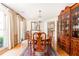 Formal dining room with hardwood floors, elegant chandelier, and china cabinet at 4579 Blakedale Ne Cir, Roswell, GA 30075