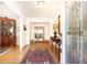 Elegant foyer with hardwood floors, decorative rug, and bright lighting fixture at 4579 Blakedale Ne Cir, Roswell, GA 30075