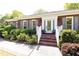 Close-up of home's brick porch, white trim and shutters, and lush landscaping at 4579 Blakedale Ne Cir, Roswell, GA 30075