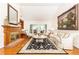 Spacious living room boasting hardwood floors, fireplace, large windows and elegant furnishings at 4579 Blakedale Ne Cir, Roswell, GA 30075