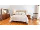 Bright main bedroom features wood floors, natural light, and elegant decor with a chair for relaxing at 4579 Blakedale Ne Cir, Roswell, GA 30075