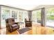 Sunroom with hardwood floors, multiple windows overlooking the backyard, and two armchairs at 4579 Blakedale Ne Cir, Roswell, GA 30075