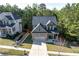 Aerial front view of home with driveway, lawn and landscaping at 6424 Barker Station Walk, Sugar Hill, GA 30518