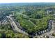 Expansive aerial shot showcasing a neighborhood with a soccer field nestled within lush greenery at 6424 Barker Station Walk, Sugar Hill, GA 30518