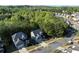 Beautiful aerial view of two homes in a tranquil neighborhood setting surrounded by mature trees at 6424 Barker Station Walk, Sugar Hill, GA 30518