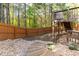 Backyard with wooden fence, wooden stairs and natural landscaping at 6424 Barker Station Walk, Sugar Hill, GA 30518