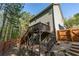 Back of home featuring deck, stairs, door to basement and landscaping at 6424 Barker Station Walk, Sugar Hill, GA 30518