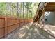 Fenced backyard featuring trees and wooden fence at 6424 Barker Station Walk, Sugar Hill, GA 30518