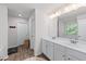 Bright bathroom with double sink vanity, and wood look floors at 6424 Barker Station Walk, Sugar Hill, GA 30518