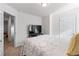 Comfortable bedroom with TV, neutral carpet, and doorway to another room at 6424 Barker Station Walk, Sugar Hill, GA 30518
