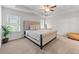 This spacious bedroom features a tray ceiling, large windows, and ample natural light at 6424 Barker Station Walk, Sugar Hill, GA 30518