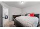 Bedroom boasts a dark wood frame bed and natural light from an open door at 6424 Barker Station Walk, Sugar Hill, GA 30518