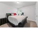 A well-lit bedroom features a large bed, a nightstand, and a cozy, inviting atmosphere at 6424 Barker Station Walk, Sugar Hill, GA 30518
