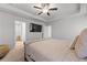 The primary bedroom offers a tray ceiling, carpet floors, and a large TV at 6424 Barker Station Walk, Sugar Hill, GA 30518