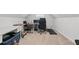 Bonus room with multiple desks and chairs, providing a versatile workspace or recreation area at 6424 Barker Station Walk, Sugar Hill, GA 30518