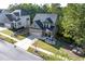 Charming two-story home featuring a brick facade, well-manicured lawn, and inviting front porch at 6424 Barker Station Walk, Sugar Hill, GA 30518