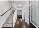 Inviting foyer with hardwood floors, staircase, and view into the living room, creating a seamless transition at 6424 Barker Station Walk, Sugar Hill, GA 30518