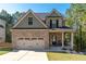 Charming two-story home with brick and siding exterior, two-car garage, and inviting front porch at 6424 Barker Station Walk, Sugar Hill, GA 30518