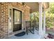 Close-up of the front porch featuring classic columns, rocking chairs, and a welcoming entrance at 6424 Barker Station Walk, Sugar Hill, GA 30518