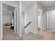 Upstairs hallway leads to bedrooms and bathroom; neutral carpet and paint throughout at 6424 Barker Station Walk, Sugar Hill, GA 30518