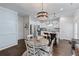 Charming kitchen with stainless appliances, granite countertops, and dark wood flooring near the dining area at 6424 Barker Station Walk, Sugar Hill, GA 30518