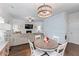 Dining area and living room combination boasts hardwood floors, modern lighting, and an open layout at 6424 Barker Station Walk, Sugar Hill, GA 30518