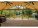 Covered back porch featuring wood floors, open views, and comfortable seating for relaxation and outdoor enjoyment at 125 Mayo Rd, Covington, GA 30014