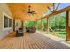 Spacious back porch with wood floors, comfortable seating, and scenic views of the surrounding trees and greenery at 125 Mayo Rd, Covington, GA 30014